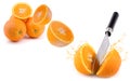 Three oranthree oranges, whole and cut with splashes of juice close-up on a white background, horizontal viewges close-up on a Royalty Free Stock Photo