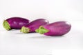 Three organic eggplant on white