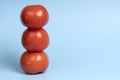 Three organic tomatoes stand in a column Royalty Free Stock Photo