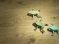 Three Origami Frogs on wooden background