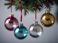 Three Ornaments Hanging From A Christmas Tree. Generative AI