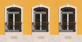 Three Ornate Windows On Yellow Exterior Wall Royalty Free Stock Photo