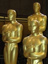 Three Oscar statues stand outside at the Academy Awards Royalty Free Stock Photo
