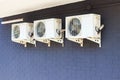 three outdoor air conditioning units hanging on the wall Royalty Free Stock Photo