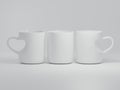 Three 11 oz Heart Shaped White Ceramic Cups Royalty Free Stock Photo