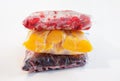 Three packages with frozen fruts on white background, front view. Royalty Free Stock Photo