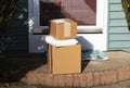 Three packages left at front door Royalty Free Stock Photo