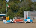 Three paddle boats with Italian flag on a empty beach in Caorle, Venice, Italy, at the end of the summer season Royalty Free Stock Photo