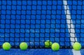 three paddle tennis balls next to the net of a paddle tennis court Royalty Free Stock Photo