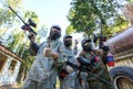 Three paintball players with smoke grenade posing in masks