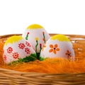 Three painted colorful Easter eggs in a basket Royalty Free Stock Photo