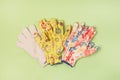 Three Pair of Gardening Gloves on Green Background Gardening Concept Flat Lay Top View