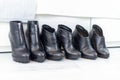 three pairs of black boots with high heels in front of a white closet Royalty Free Stock Photo