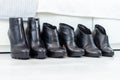 three pairs of black boots with high heels in front of a white closet Royalty Free Stock Photo