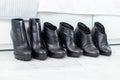 three pairs of black boots with high heels in front of a white closet Royalty Free Stock Photo