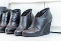 three pairs of black boots with high heels in front of a white closet Royalty Free Stock Photo