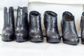 three pairs of black boots with high heels in front of a white closet Royalty Free Stock Photo