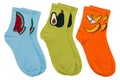 Three pairs of colored socks with drawings of fruits, on a white background