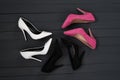 Three pairs of different high heel shoes. Black wooden background Royalty Free Stock Photo