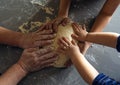 Three pairs of hands holding the dough Royalty Free Stock Photo