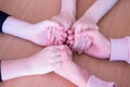 Three pairs of hands of teenage girls on the table close up