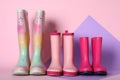 Three pairs of rubber boots on color background Royalty Free Stock Photo