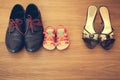 Three pairs of shoes: men, women and children.