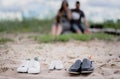 Three pairs of shoes on the sand - adult and child for newborns. Royalty Free Stock Photo
