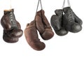 three pairs of very old vintage leather boxing gloves hanging on laces Royalty Free Stock Photo
