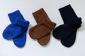 Three pairs of warm socks on a white background, blue, brown, black Royalty Free Stock Photo