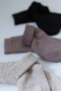 Three pairs of warm socks on a white background, white, brown, black Royalty Free Stock Photo
