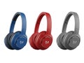 Three pairs of wireless headphones in blue, red, and gray Royalty Free Stock Photo
