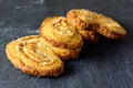 Three palmier cookies on a black board