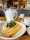 Three pancakes with herbs in a light round plate