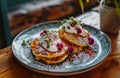 three pancakes and yogurt on a plate