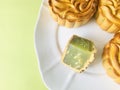 Cutted mooncake with three Pandan mooncake on light green background. copy space. Royalty Free Stock Photo