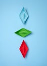 Three paper boats on a blue background, top view Royalty Free Stock Photo