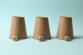 Three paper cups and dices on light blue. Thimblerig game Royalty Free Stock Photo