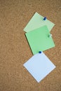 Three paper notes green, white and yellow color on a cork Board, attached with a white pushpin. Copy space Royalty Free Stock Photo