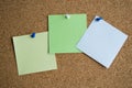 Three paper notes green, white and yellow color on a cork Board, attached with a white pushpin. Copy space Royalty Free Stock Photo