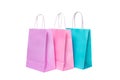 Three paper pink, purple,blue shopping bags isolated. Top view Royalty Free Stock Photo