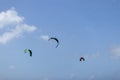 Three parachutes in the blue sky. Kiteboarding. Royalty Free Stock Photo