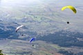 Three paraglider flies paraglider over valley on a sunny day Royalty Free Stock Photo