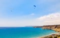 Three paragliders flying over the Kurion beach and mediterranean