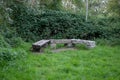 Three-part stone bench in a green park