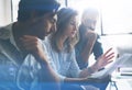 Three partners making research for new business direction. Business people meeting concept. Blurred background. Cropped. Royalty Free Stock Photo