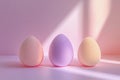 Three pastel beauty blending sponges arranged on a soft pink surface with gentle light Royalty Free Stock Photo