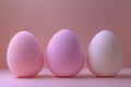 Three pastel beauty blending sponges arranged on a soft pink surface with gentle light Royalty Free Stock Photo