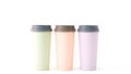 Three pastel colored reusable water bottles standing together on a white background Royalty Free Stock Photo