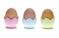 Three Pastel Egg Cups with Brown Eggs Royalty Free Stock Photo